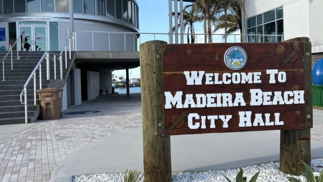 The Madeira Beach City hall with a wooden sign that says 
