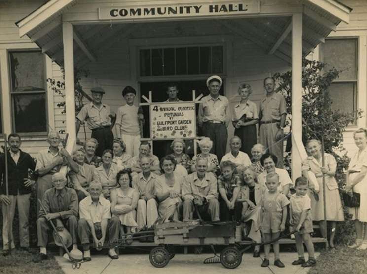 Members of the Gulfport Garden and Bird Club gather outside Community (Scout) Hall for annual petunia planting, 1947.