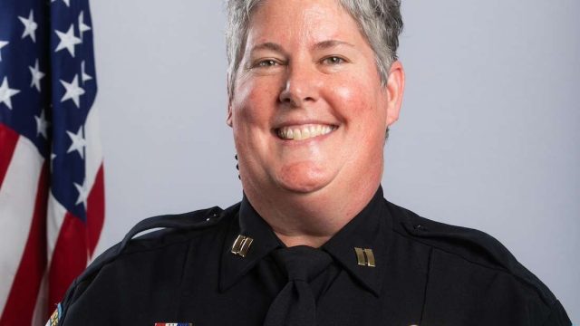 a woman with short hair and in a police uniform.