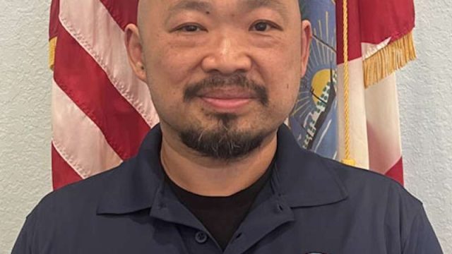 a man in a blue shirt that reads 