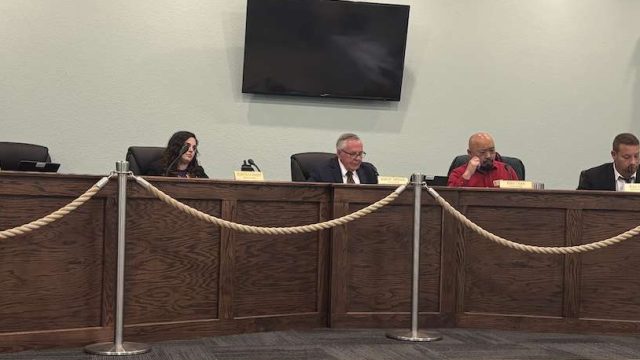 Men and women sitting on a dais.