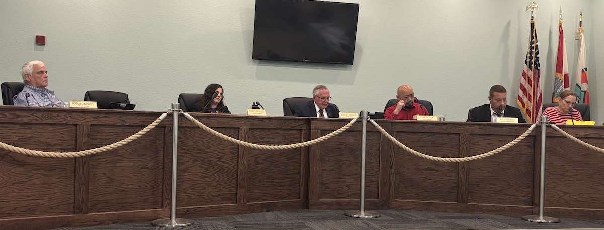 Men and women sitting on a dais.