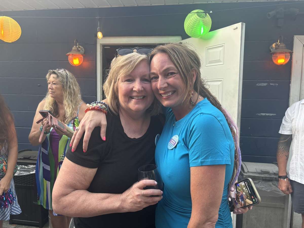 two women smiling.