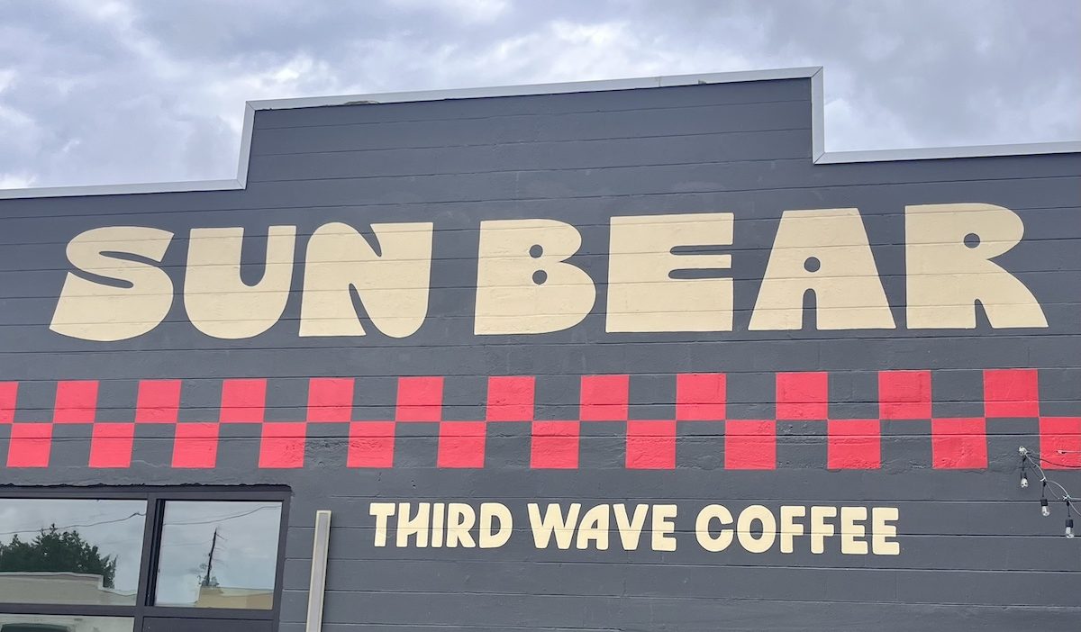 a black building that reads "Sun Bear; Third Wave Coffee"