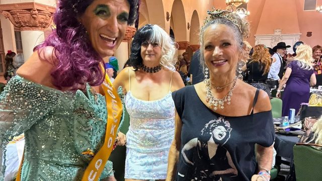 two women smiling in costumes.