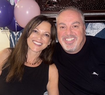 Two people, a man and a woman smiling
